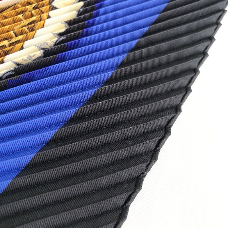 The close-up image of pleated scarf with hand-rolled edges.